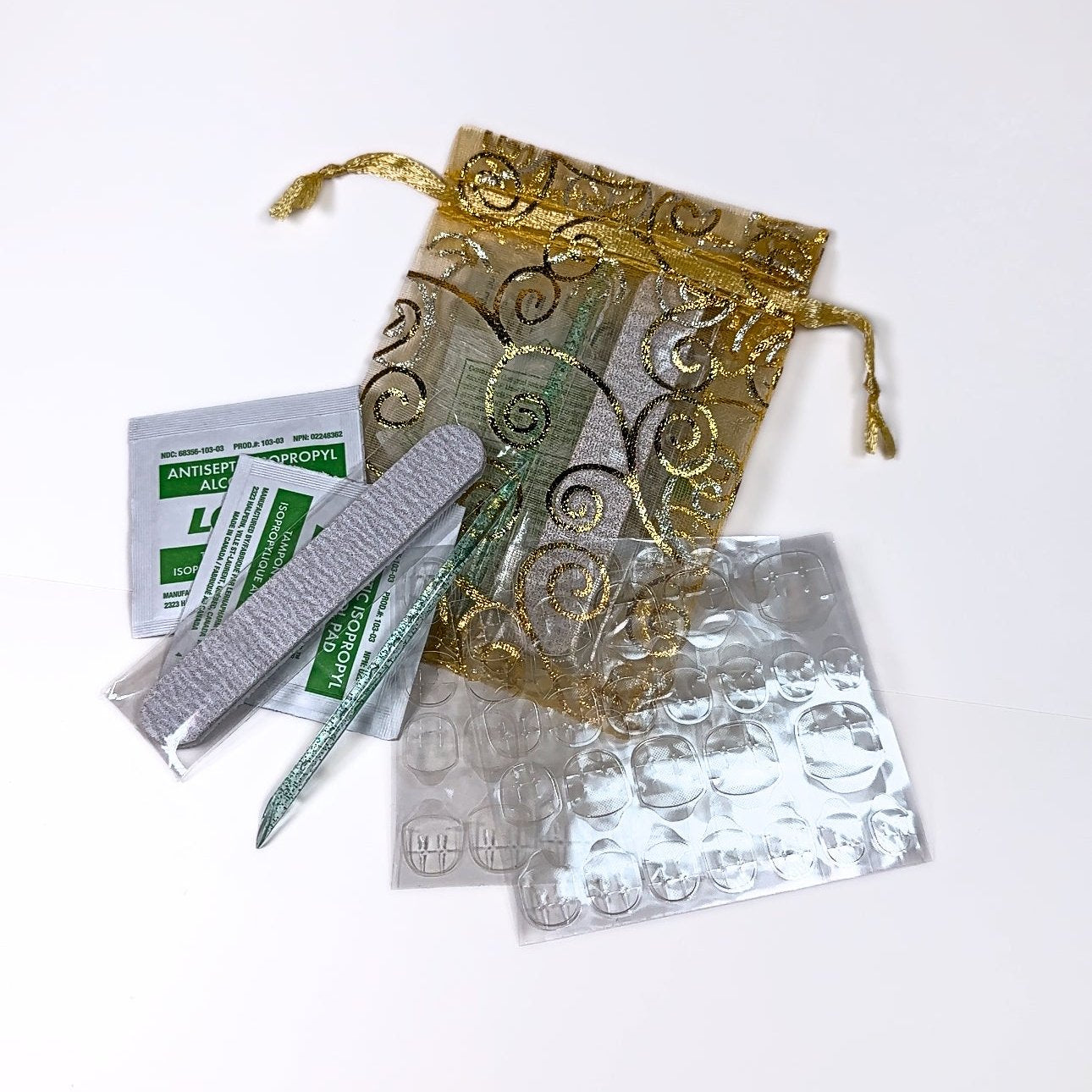 Nail Prep Kit by BYN Beauty featuring essential tools for reapplying press-on nails, including a cuticle stick, nail file, alcohol wipe, and sticky tabs, all designed to ensure a flawless and long-lasting manicure at home. Perfect for achieving salon-quality results effortlessly.