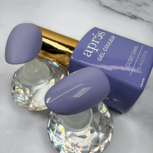 Nail polish with purple cap and gold accents on a marble surface with sample nails showing matte versus glossy topcoats