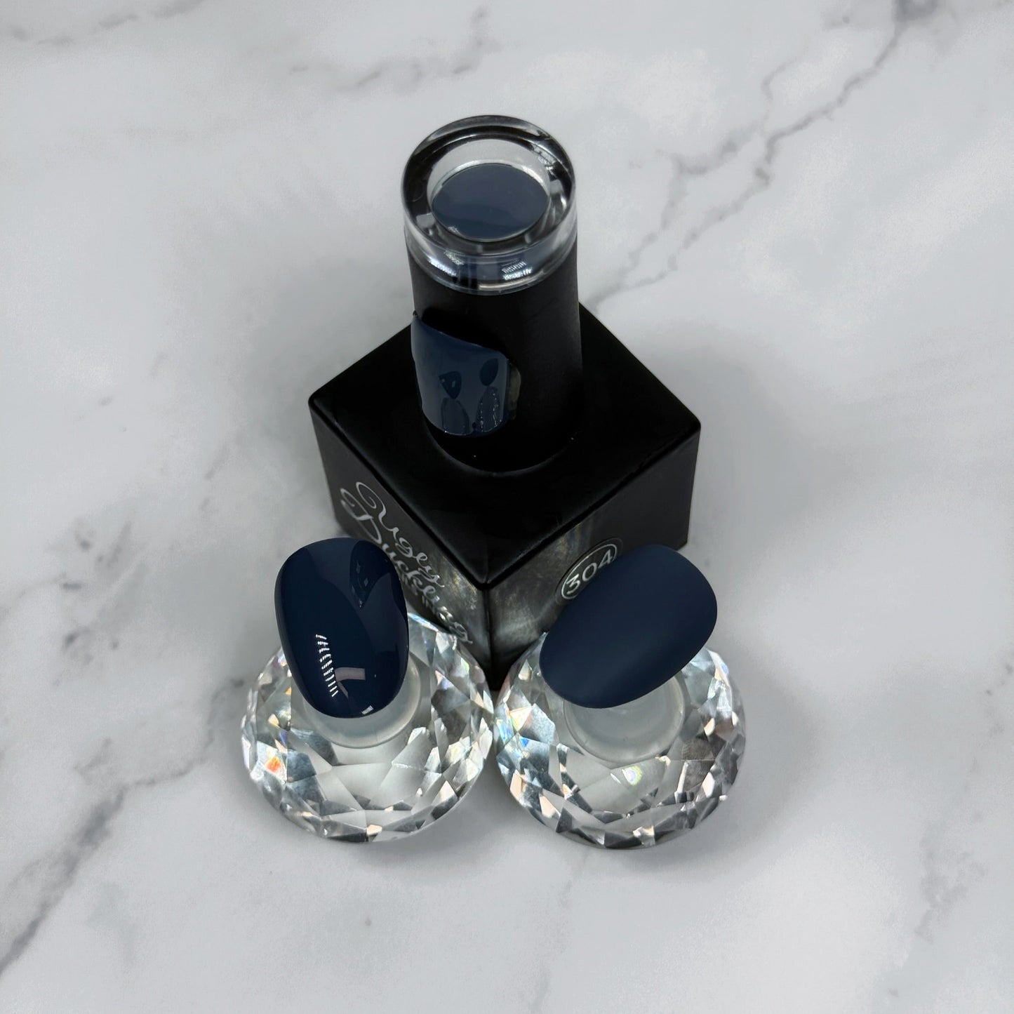 Nail polish bottle with two sample nails showing glossy and matte topcoat