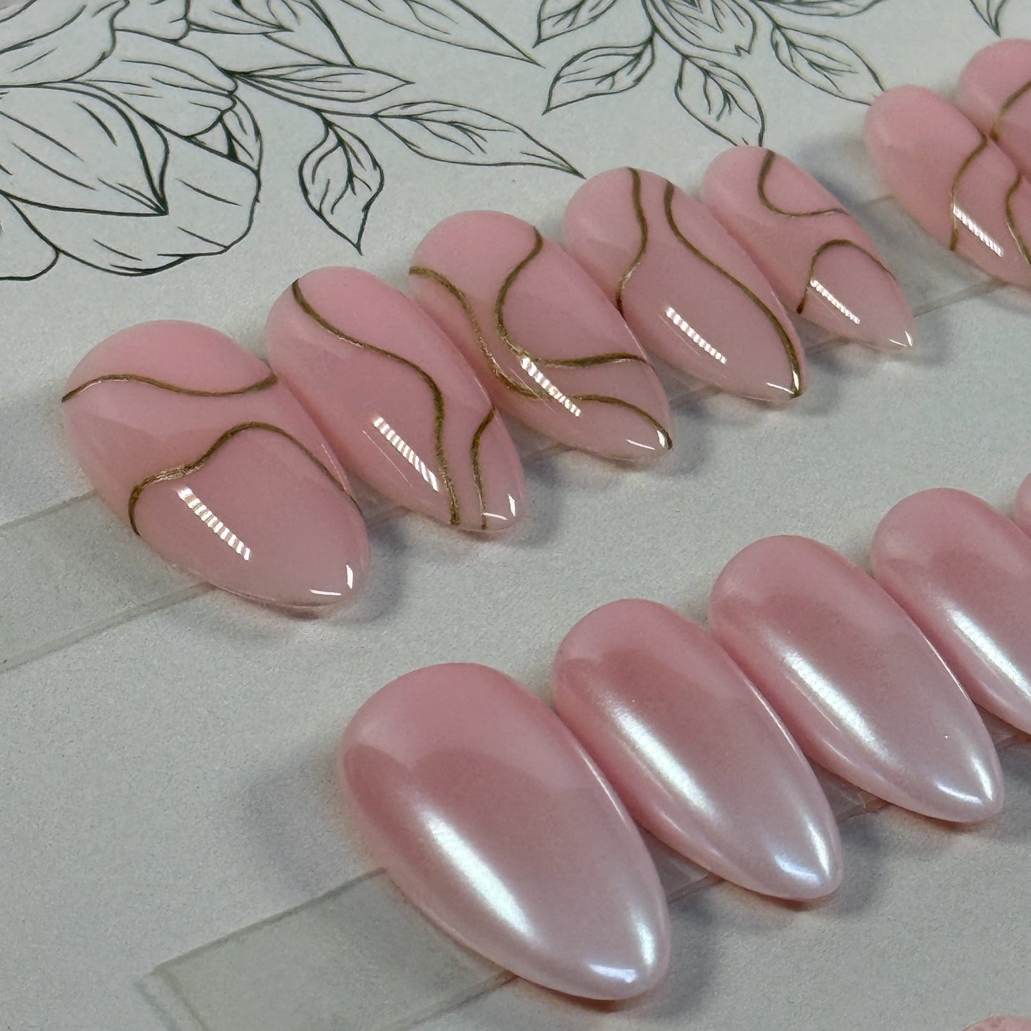 3 sets, a neutral with gold swirls, a chrome french fade and a neutral with subtle lace