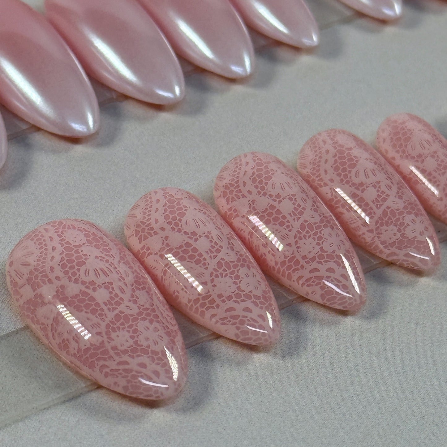 3 sets, a neutral with gold swirls, a chrome french fade and a neutral with subtle lace