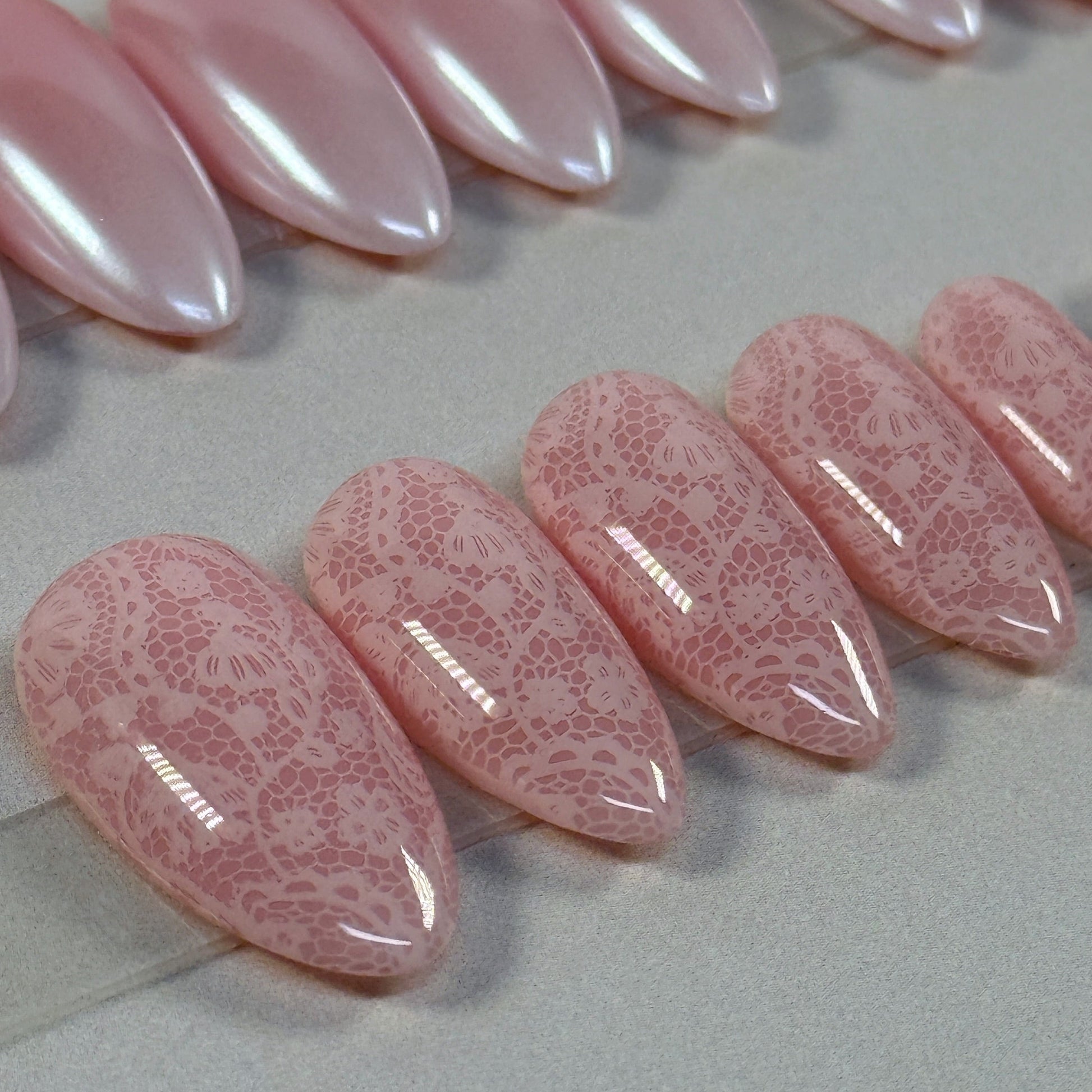 3 sets, a neutral with gold swirls, a chrome french fade and a neutral with subtle lace